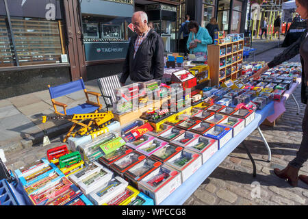 A stall selling collectible vintage toy vehicles on Guildford Antique & Brocante Street Market, High Street, Guildford, Surrey, southeast England, UK Stock Photo