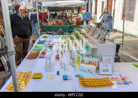 Stall selling modern glasswork in Guildford Antique & Brocante Street Market, High Street, Guildford, Surrey, southeast England, UK Stock Photo