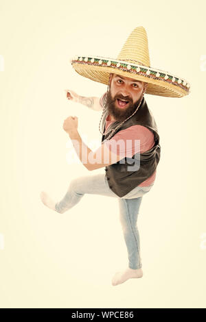 Mexican energetic temper. Man bearded cheerful guy wear sombrero mexican hat. Mexican party concept. Celebrate traditional mexican holiday. Guy happy cheerful face having fun dancing and jumping. Stock Photo