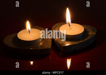 Lighted candles in the dark Stock Photo