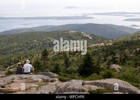 Hikers relaxing on the top of Cadillac Mountain.Acadia National Park.Mount Desert.Maine.USA Stock Photo