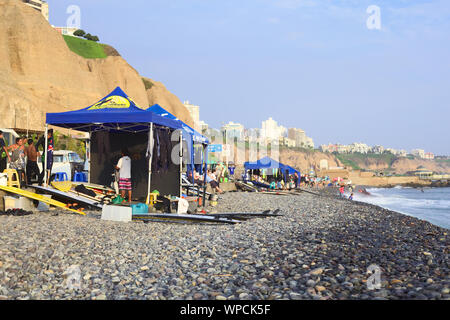LIMA, MIRAFLORES - APRIL 2, 2012: Unidentified people at surf school stands on April 2, 2012 on the coast of Miraflores, Lima, Peru. Stock Photo