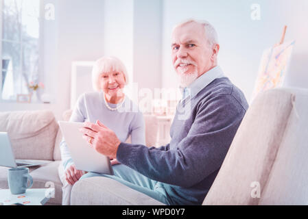 Beaming pensioners feeling happy while spending weekend together Stock Photo