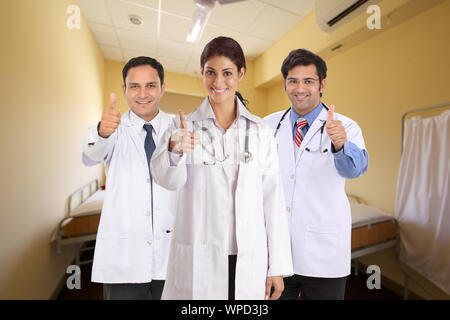Confident group of doctors showing thumbs up sign Stock Photo