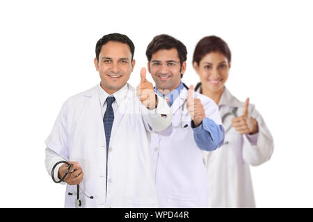 Confident group of doctors showing thumbs up sign Stock Photo