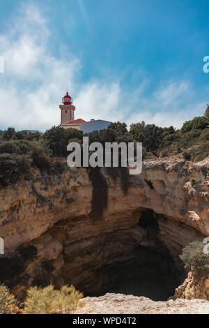 The Alfanzina lighthouse during a hot sunny day near Carvoeiro in Portugal Stock Photo