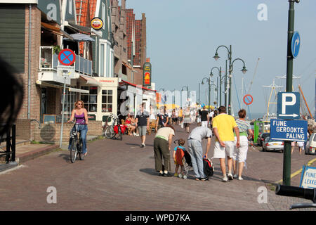 A street in Volendam village that well-preserved with traditional wooden houses, restaurants, souvenir shops and photo studios. Stock Photo