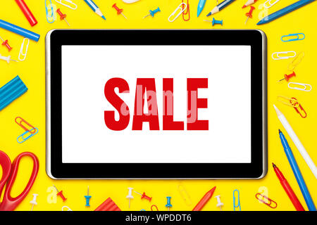Colored stationery and tablet on a yellow background. Office supplies sale. The concept of creativity, education, ideas, school, etc. Stock Photo