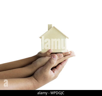 Hands of family father mother and daughther holding the wooden house model metaphor dream for home building and decoration or saving money for real es Stock Photo