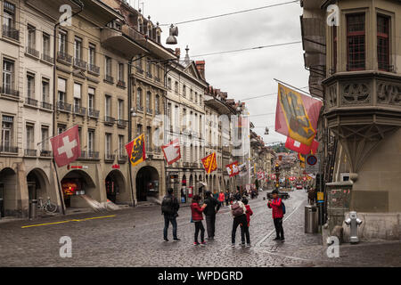 Bern, Switzerland - May 7, 2017: Street view of Kramgasse. It is one of the principal streets in the Old City of Bern. Tourists take photos under colo Stock Photo