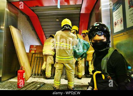 Hong Kong, China. 06th, September 2019. Protesters vandalize MTR stations at Prince Edward, Mong Kok, and Yau Ma Tei. The Protesters demand the MTR Corporation to release CCTV clip from 31st Aug. where Police deployed tear gas inside the Metro Station. Here firefigthers are clearing the entrance to a metro station. Stock Photo