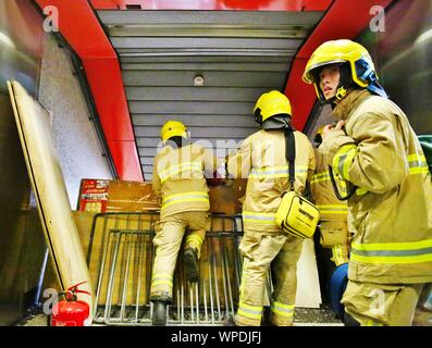 Hong Kong, China. 06th, September 2019. Protesters vandalize MTR stations at Prince Edward, Mong Kok, and Yau Ma Tei. The Protesters demand the MTR Corporation to release CCTV clip from 31st Aug. where Police deployed tear gas inside the Metro Station. Here firefigthers are clearing the entrance to a metro station. Stock Photo