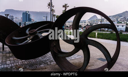 Angular Mass sculpture at the V&A Waterfront in the South African city of Cape Town with the landmark Table Mountain and Lion's Head Stock Photo