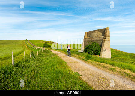 A cyclist passes Abbots Cliffe sound mirror on the Kent coast nr Dover. Stock Photo