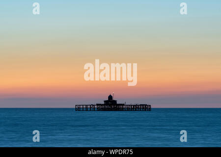 Sunset at the isolated pier head off the Kent coast at Herne Bay. Stock Photo