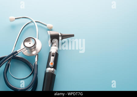 Otoscope with stethoscope on blue background. Stock Photo
