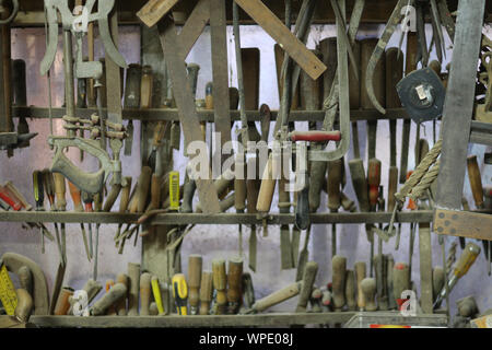 Carefully hanging hand tools in the metal workshop Stock Photo