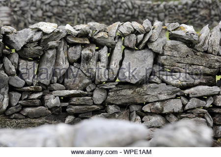 A beautiful grey stone wall on the island of Inisheer, one of the Aran Islands off the coast of Galway, Ireland. Stock Photo