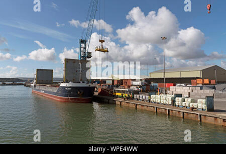 Poole Harbour, Dorset, England, UK. September 2019. The Valiant a general cargo vessel unloading from her berth in Poole Harbour. Stock Photo