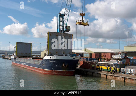 Poole Harbour, Dorset, England, UK. September 2019. The Valiant a general cargo vessel unloading from her berth in Poole Harbour. Stock Photo