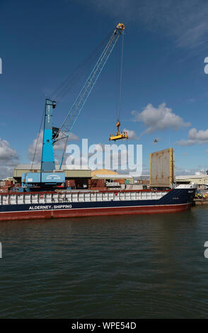 Poole Harbour, Dorset, England, UK. September 2019. The Valiant a general cargo vessel unloading from her berth in Poole Harbour. Stock Photo