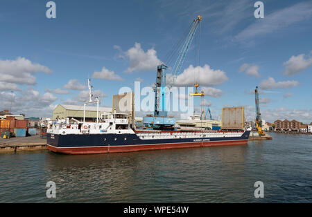 Poole Harbour, Dorset, England, UK. September 2019. The Valiant a general cargo vessel unloading from her berth in Poole Harbour. Stock Photo