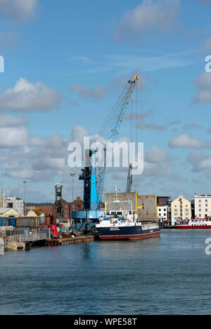 Poole Harbour, Dorset, England, UK. September 2019. The Valiant a general cargo vessel unloading from her berth in Poole Harbour. Stock Photo