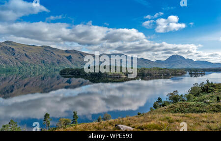 LOCH MAREE WESTER ROSS HIGHLANDS SCOTLAND LOOKING TOWARDS SLIOCH WITH THE ISLANDS AND MIRROR CALM WATER IN LATE SUMMER Stock Photo