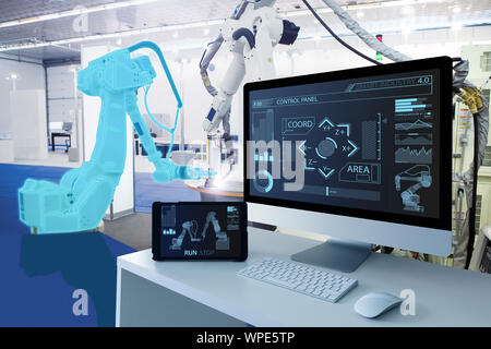 Computer and digital tablet for control of robots in a smart factory. Smart industry 4.0 concept Stock Photo