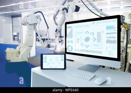 Computer and digital tablet for control of robots in a smart factory. Smart industry 4.0 concept Stock Photo