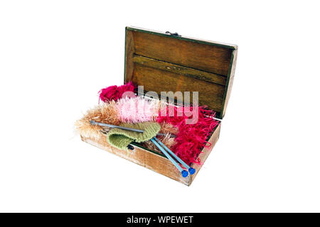 A wooden craft box containing knitting, needles, fluffy yarn and wool, isolated on a white background Stock Photo