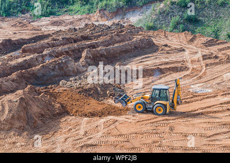 Wheel loader excavator machine working in construction site. wheel loader at sandpit during earthmoving works. Stock Photo