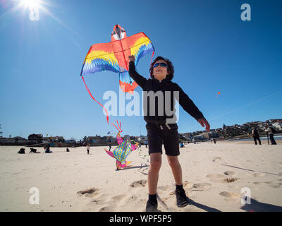 Boy flying kite on Bondi Beach at the 42nd annual Festival of the Winds, September 2019 Stock Photo
