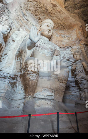 Weathered Buddha statue in cave 3 of the Yungang Grottoes near Datong Stock Photo