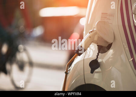 Charging rental electric car on the street Stock Photo
