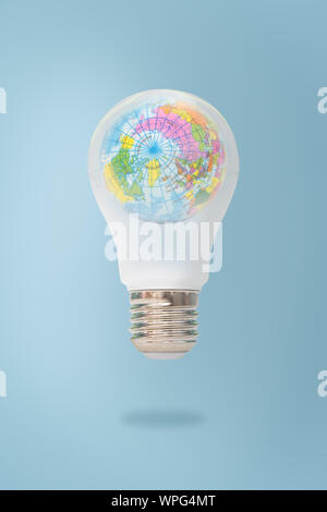 Blue world map in light bulb isolated on white background, symbolizing environmental care or green energy, Elements of this image furnished by NASA. Stock Photo