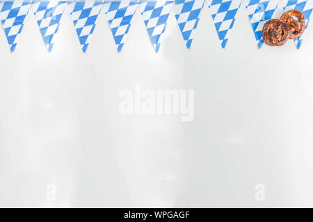 Oktoberfest festive cutlery set  with with a traditional checkered  tablecloth, plate, pretzel, fork, knife and a glass of beer. background for Restor Stock Photo