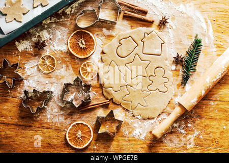rolled dough with carved gingerbread christmas figures Stock Photo