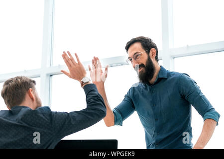 business colleagues giving each other a high five Stock Photo