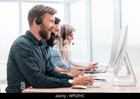call center employees work on modern computers Stock Photo