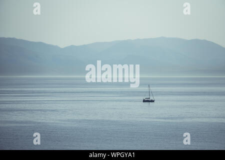 A sea landscape with a boat in Corfù, greece Stock Photo