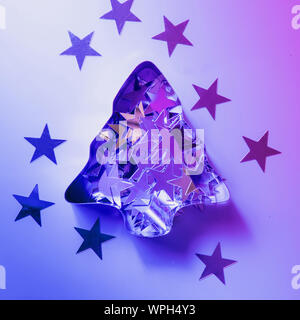 Christmas disco and mirror ball on neon pink and blue. Creative Xmas party background with copy space. Stock Photo