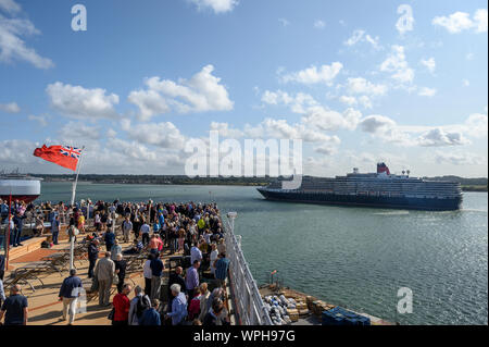 Cunard's Queen Victoria sails past the Queen Elizabeth as she leaves port at Southampton, Hampshire, England, United Kingdom. Stock Photo