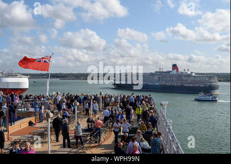 Cunard's Queen Victoria sails past the Queen Elizabeth as she leaves port at Southampton, Hampshire, England, United Kingdom. Stock Photo