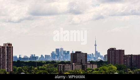 TORONTO, ONTARIO, CANADA - JULY 10, 2016: Older apartment buildings stand among trees in suburban Etobicoke, with the dense downtown in the distance. Stock Photo