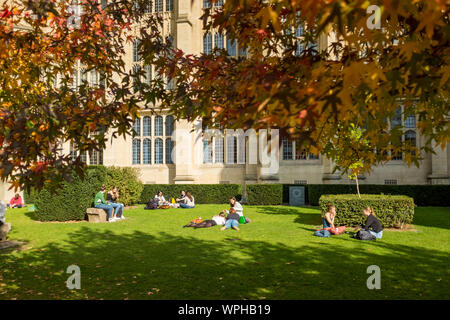Student of University of Bristol enjoying sunny day sitting or lying on grass, Bristol, UK (students in focus.  See WPHB11 for students out of focus) Stock Photo