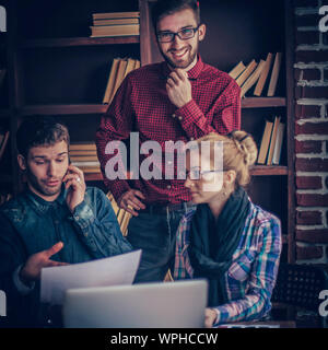 group of creative designers discuss the color palette in a moder Stock Photo