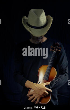 Man playing violin on dark tone Stock Photo