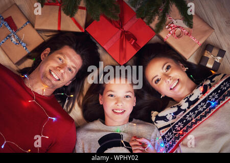 Beautiful family with presents under Christmas tree Stock Photo