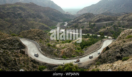 The Khyber Pass in Pakistan. Vehicles are on the Khyber Pass on the Pakistan side. The Khyber Pass is a road from Peshawar, Pakistan to Afghanistan. Stock Photo